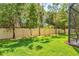 A well-maintained backyard with a white fence and mature trees provides privacy and greenery at 7844 52Nd E Ter, Bradenton, FL 34203