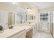 Well-lit bathroom featuring a double vanity, large mirror, and a walk-in shower at 7844 52Nd E Ter, Bradenton, FL 34203
