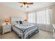 Cozy bedroom with a bed, nightstands, and sheer curtains allowing natural light at 7844 52Nd E Ter, Bradenton, FL 34203
