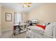 Comfortable bedroom featuring a desk, TV, and a cozy bed with colorful pillows at 7844 52Nd E Ter, Bradenton, FL 34203