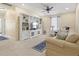 Bright bonus room with a ceiling fan, built-in shelving, and comfortable seating arrangement at 7844 52Nd E Ter, Bradenton, FL 34203