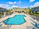 A community pool offers a refreshing amenity, complete with poolside seating and lush landscaping at 7844 52Nd E Ter, Bradenton, FL 34203