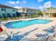 A refreshing community pool is surrounded by comfortable lounge chairs and lush landscaping at 7844 52Nd E Ter, Bradenton, FL 34203