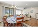 Open concept dining and living room featuring hardwood floors and sliding glass doors to the patio at 7844 52Nd E Ter, Bradenton, FL 34203