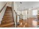 Hardwood staircase leading to an open-concept living space with a kitchen and dining area at 7844 52Nd E Ter, Bradenton, FL 34203
