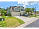 Inviting two-story home with a two-car garage, grassy lawn, and lush palms at 7844 52Nd E Ter, Bradenton, FL 34203