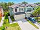 Beautiful townhome showcasing a well-manicured lawn, two-car garage, and landscaped grounds at 7844 52Nd E Ter, Bradenton, FL 34203