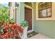 Inviting front entrance with a brown door, plants, and decorative accents at 7844 52Nd E Ter, Bradenton, FL 34203