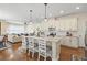 Open kitchen featuring white cabinets, a large island, and modern appliances at 7844 52Nd E Ter, Bradenton, FL 34203