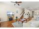 Open-concept living area with hardwood floors, connecting living room, kitchen, and staircase at 7844 52Nd E Ter, Bradenton, FL 34203