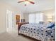 Main bedroom with a ceiling fan, tapestry, large window, and a comfortable bed at 7844 52Nd E Ter, Bradenton, FL 34203