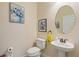 Cozy half bathroom with a pedestal sink and decorative accents at 7844 52Nd E Ter, Bradenton, FL 34203