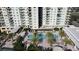 Aerial view of a luxurious condo complex featuring a pool, hot tub, and beautiful landscaping at 800 N Tamiami Trl # 604, Sarasota, FL 34236