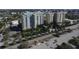 Scenic aerial view of modern condominiums with lush landscaping and parking at 800 N Tamiami Trl # 604, Sarasota, FL 34236