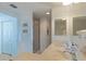 Bright bathroom featuring double sinks and glass enclosed shower with door leading to toilet at 800 N Tamiami Trl # 604, Sarasota, FL 34236