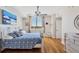 Bright bedroom with a decorative white bed frame, hardwood floors, and a picturesque window view at 800 N Tamiami Trl # 604, Sarasota, FL 34236