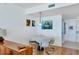 Inviting dining area with a round table and seating for four, complemented by nautical-themed artwork and lighting at 800 N Tamiami Trl # 604, Sarasota, FL 34236