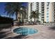 Inviting hot tub next to a pool, surrounded by palm trees and lounge chairs at 800 N Tamiami Trl # 604, Sarasota, FL 34236