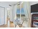 Bright lanai featuring tile floors, a small bistro table, and a floor-to-ceiling window for a great view at 800 N Tamiami Trl # 604, Sarasota, FL 34236