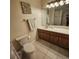 Cozy bathroom features tile flooring, a framed mirror, and a wooden vanity with decorative towel racks at 8110 Villa Grande Ct, Sarasota, FL 34243