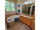 Bathroom featuring a soaking tub and window at 8110 Villa Grande Ct, Sarasota, FL 34243