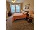 Comfortable bedroom featuring a bed, dresser, and bright window with shutters at 8110 Villa Grande Ct, Sarasota, FL 34243