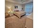 The well-lit bedroom features shutters, a ceiling fan, and neutral color carpets at 8110 Villa Grande Ct, Sarasota, FL 34243