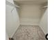 Carpeted walk-in closet featuring wire shelving at 8110 Villa Grande Ct, Sarasota, FL 34243