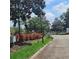 Gated entrance to a well-maintained community with colorful landscaping at 8110 Villa Grande Ct, Sarasota, FL 34243