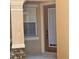 Home entryway showcasing a window, a front door, and a stone pillar detail at 8110 Villa Grande Ct, Sarasota, FL 34243