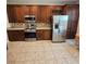 Kitchen featuring stainless steel appliances, wood cabinets, tile flooring and eat in dining area at 8110 Villa Grande Ct, Sarasota, FL 34243