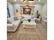 Inviting living room features light colored sofas, ceiling fan and decorative stacked stone feature wall at 8110 Villa Grande Ct, Sarasota, FL 34243