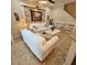 Comfortable living room features light colored sofas, ceiling fan and decorative stacked stone feature wall at 8110 Villa Grande Ct, Sarasota, FL 34243