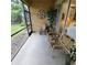 Screened in patio with furniture featuring sliding glass door to interior of the house at 8110 Villa Grande Ct, Sarasota, FL 34243