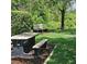 Community picnic area with a table and benches, shaded by trees at 8110 Villa Grande Ct, Sarasota, FL 34243
