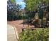 Community playground with slides, climbing equipment, and shade trees at 8110 Villa Grande Ct, Sarasota, FL 34243