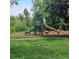 Community playground with slides and climbing structures on a grassy lawn at 8110 Villa Grande Ct, Sarasota, FL 34243
