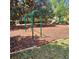 Community playground with swings and climbing bars, surrounded by lush greenery at 8110 Villa Grande Ct, Sarasota, FL 34243