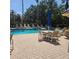 Relax by the sparkling community pool with ample seating, tables, and a beautiful view of the surrounding greenery at 8110 Villa Grande Ct, Sarasota, FL 34243