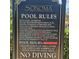 Sign displaying the community pool rules and hours, ensuring a safe and enjoyable experience for all residents at 8110 Villa Grande Ct, Sarasota, FL 34243