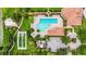 Aerial view of community pool with tennis court and lush landscaping at 8118 Stirling Falls Cir, Sarasota, FL 34243