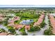 An aerial view of a community with red tile roofs, lush landscaping, and serene lakes at 8118 Stirling Falls Cir, Sarasota, FL 34243