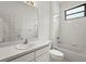 Bright bathroom features a tub-shower combination with white tiling and clean, classic fixtures at 8118 Stirling Falls Cir, Sarasota, FL 34243