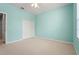 Bright bedroom with neutral carpet, ceiling fan, and ample closet space with double doors at 8118 Stirling Falls Cir, Sarasota, FL 34243