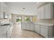 Bright kitchen featuring tile floors, stainless steel appliances, and an open layout to the pool area at 8118 Stirling Falls Cir, Sarasota, FL 34243