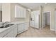 The kitchen has white appliances, including a stainless steel sink and dishwasher, providing a sleek look at 8118 Stirling Falls Cir, Sarasota, FL 34243