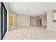 Spacious living room with tile flooring, neutral walls and door to an additional room at 8118 Stirling Falls Cir, Sarasota, FL 34243