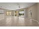 Open living room with tile flooring and sliding glass doors overlooking the pool area and outdoor space at 8118 Stirling Falls Cir, Sarasota, FL 34243