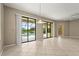 Bright living room features tile flooring with access to the patio and the swimming pool at 8118 Stirling Falls Cir, Sarasota, FL 34243
