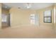 A spacious main bedroom provides an open door to the en suite bathroom and a view of the kitchen at 8118 Stirling Falls Cir, Sarasota, FL 34243